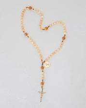 Beaded rosary with cream and orange beads and gold medal and cross details