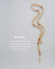 Rosary with beads on a light gray background with 5 star rating and review