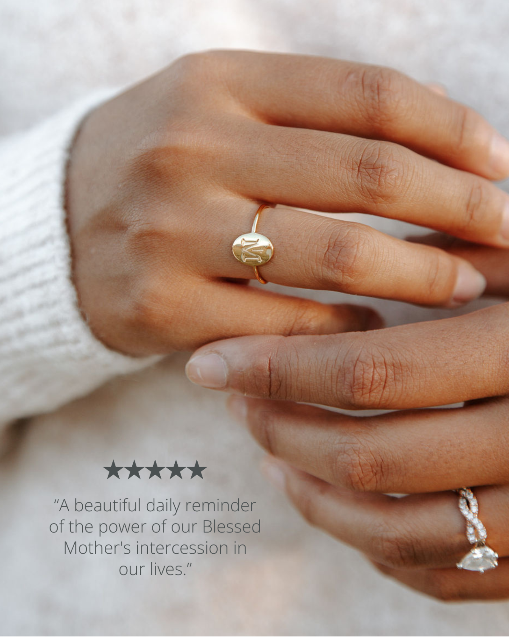 Close-up of hands wearing gold and silver rings with a neutral background