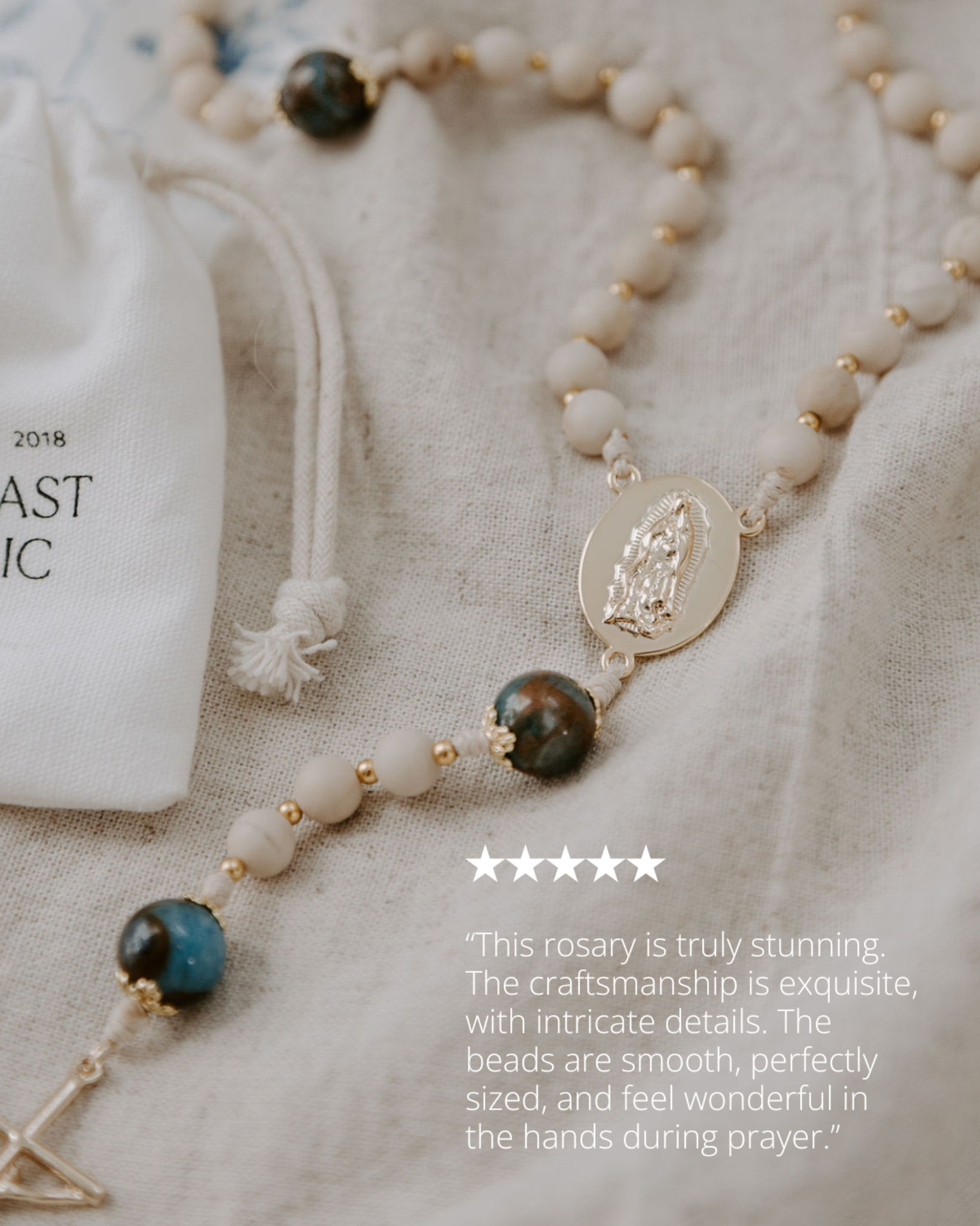 Rosary with intricate details on a textured fabric background