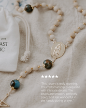 Rosary with intricate details on a textured fabric background