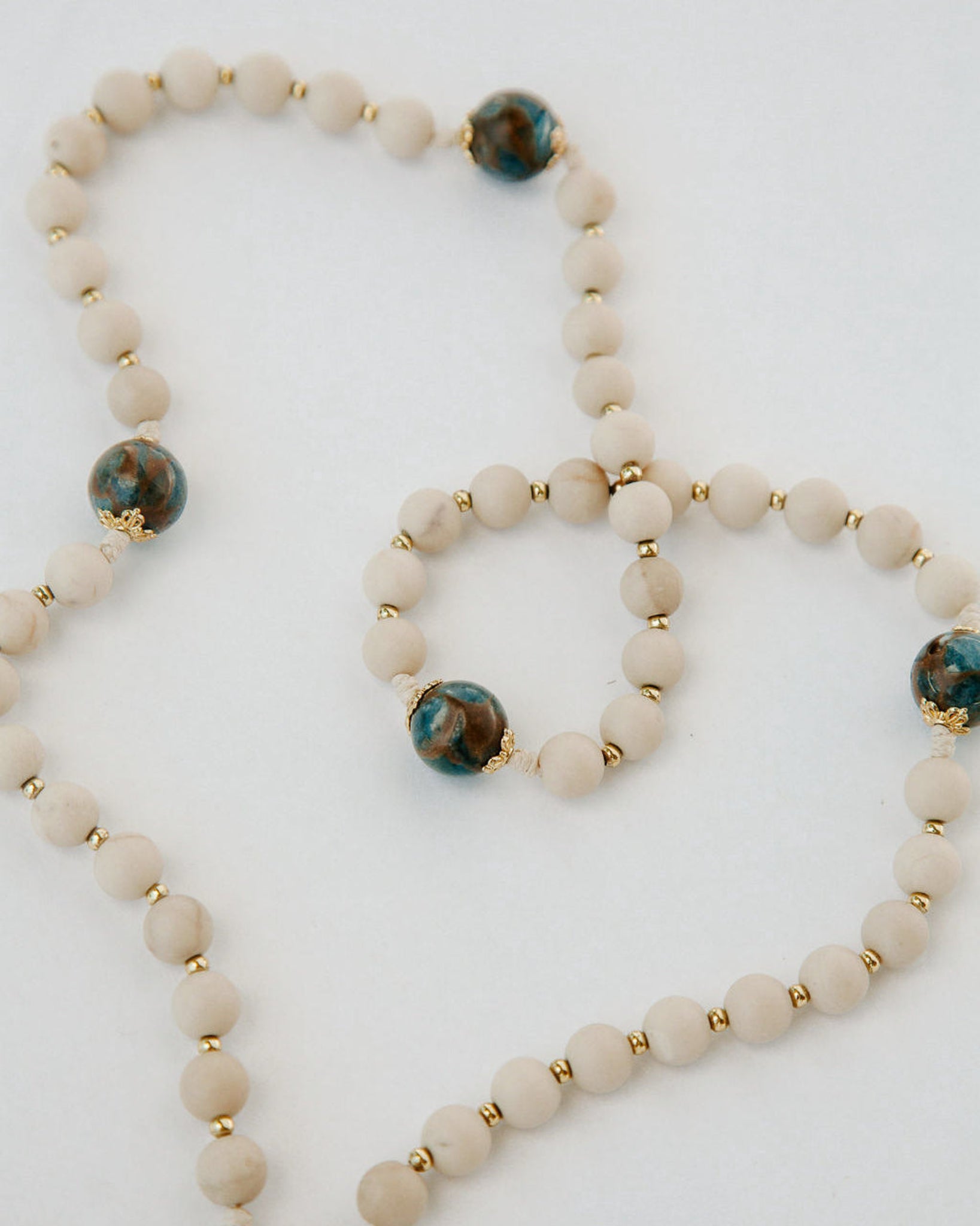 Set of beaded bracelets with gold accents on a white background