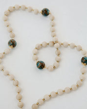 Set of beaded bracelets with gold accents on a white background