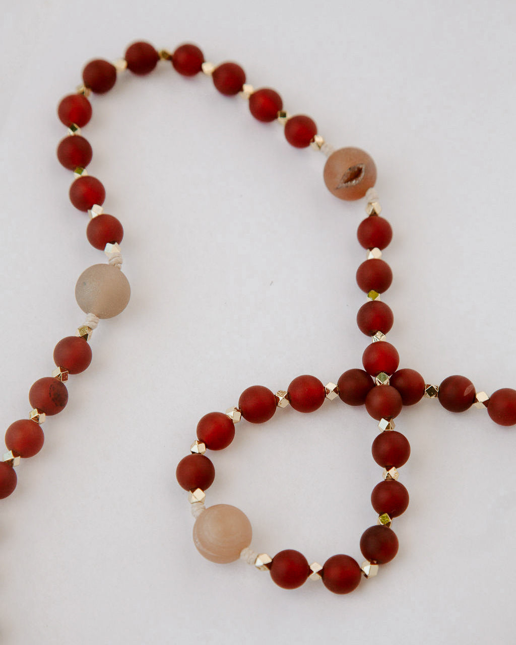 Beaded rosary with red and tan beads and gold details