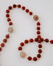 Beaded rosary with red and tan beads and gold details