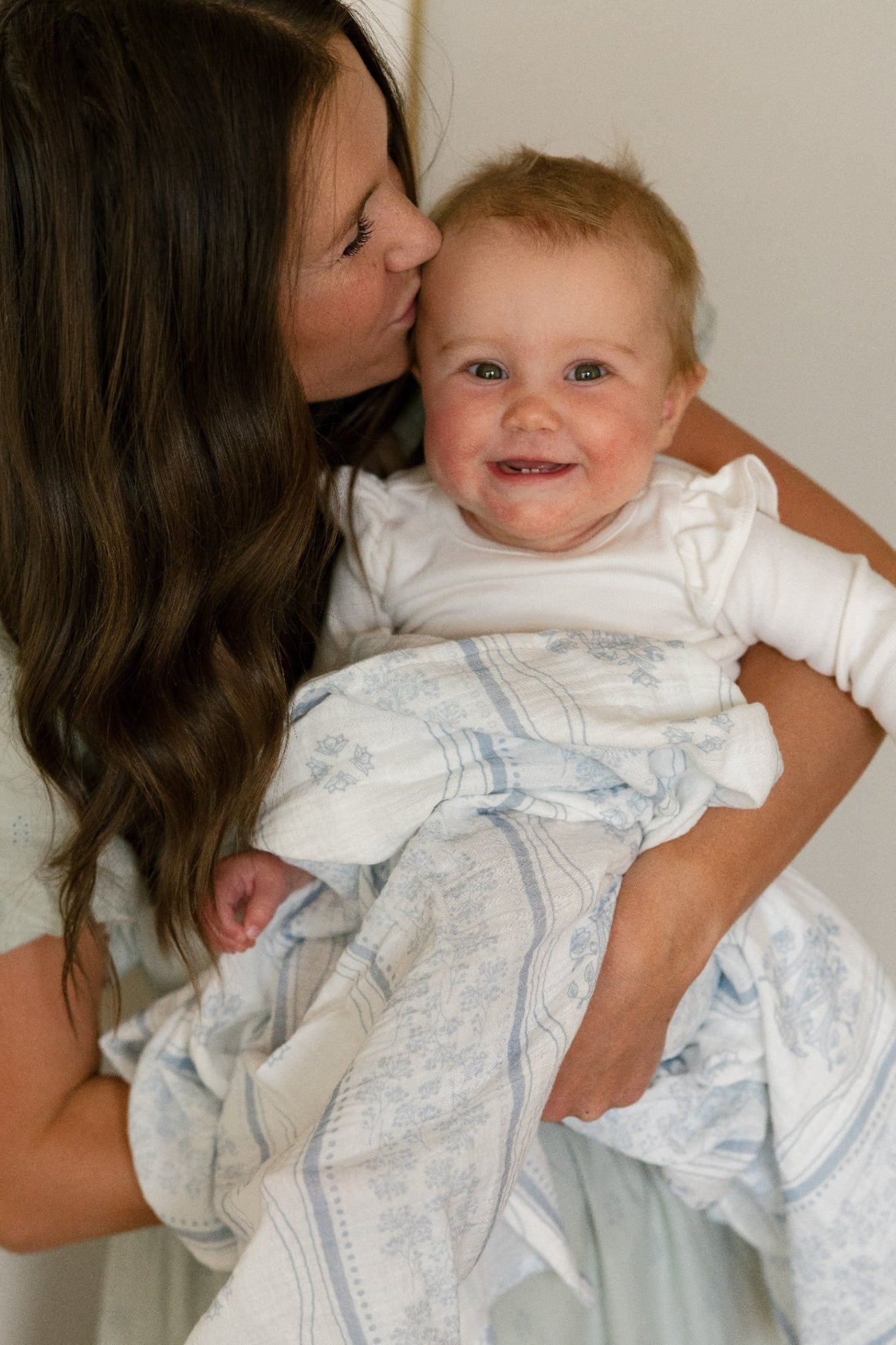 Baby with a Catholic West Coast Catholic swaddle.