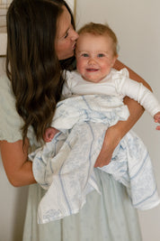 Baby with a Catholic West Coast Catholic swaddle.