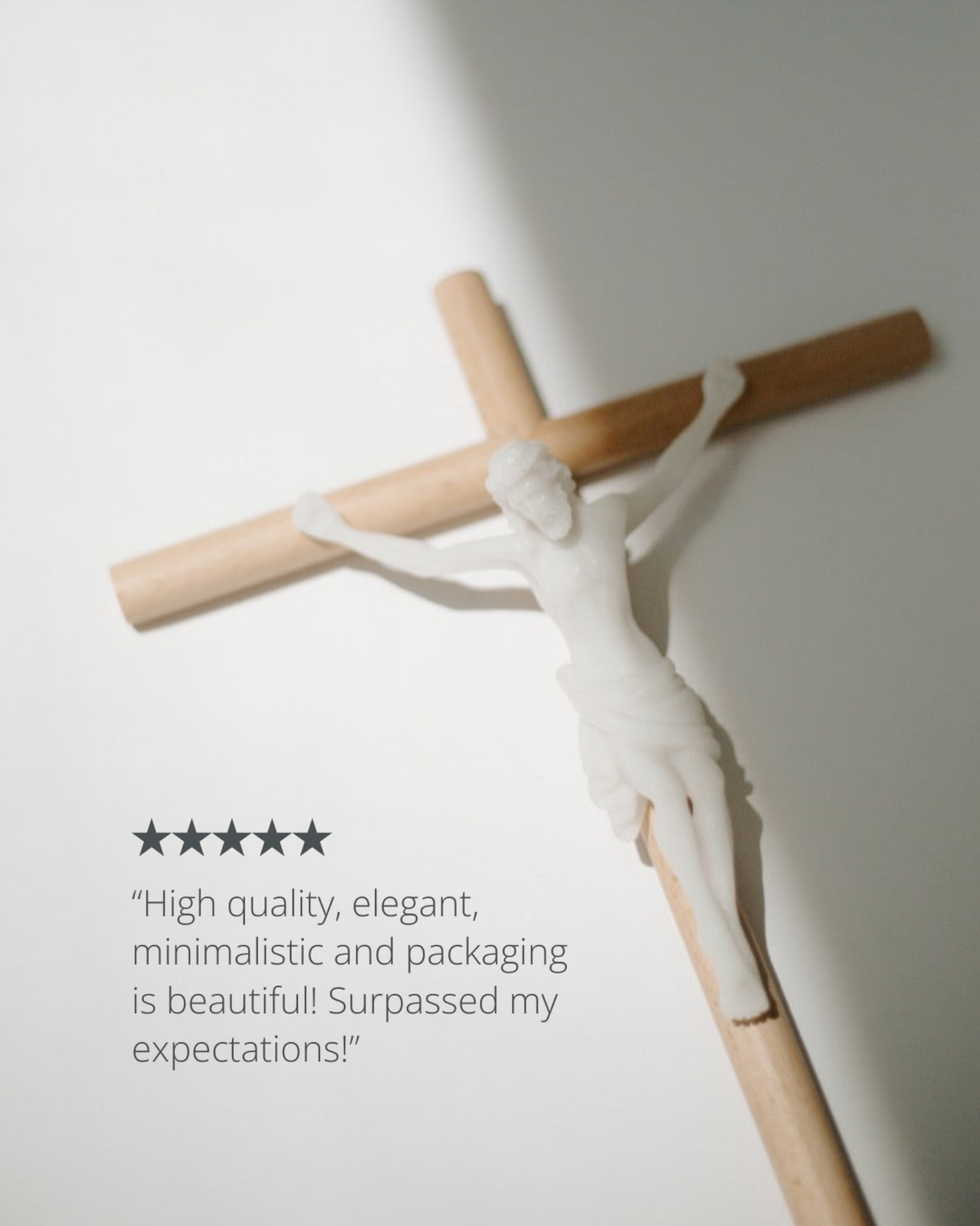 Wooden cross with white figure on a light gray background