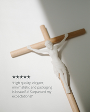 Wooden cross with white figure on a light gray background