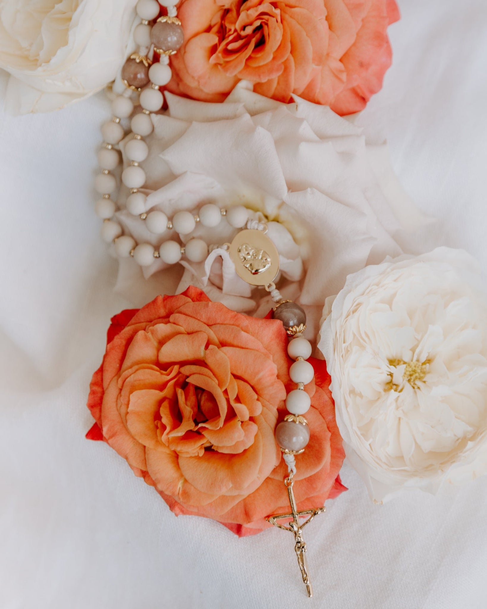 Madonna Rosary styled product photo with flowers
