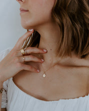 woman wearing a gold miraculous medal